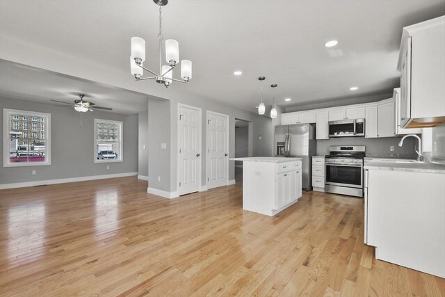 119 Tripp St, Fall River, MA 02724 - kitchen featuring stainless steel appliances, ceiling fan, a kitchen island, open floor plan, and recessed lighting