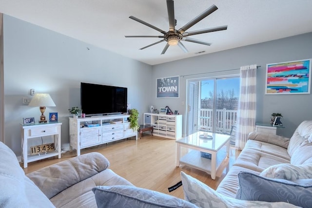 living area featuring visible vents, ceiling fan, and wood finished floors