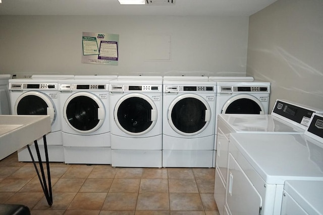 laundry area featuring washer and dryer and light tile patterned floors