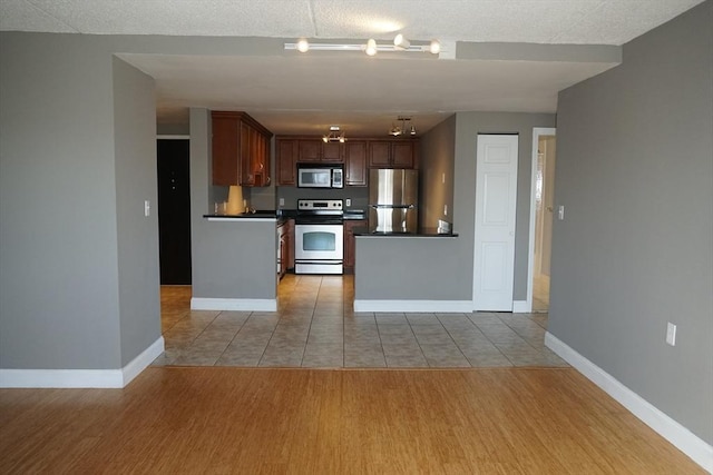 kitchen featuring appliances with stainless steel finishes and light hardwood / wood-style floors