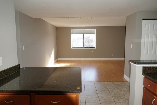 kitchen with dark stone countertops and light tile patterned floors