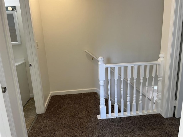 stairs featuring baseboards and carpet flooring