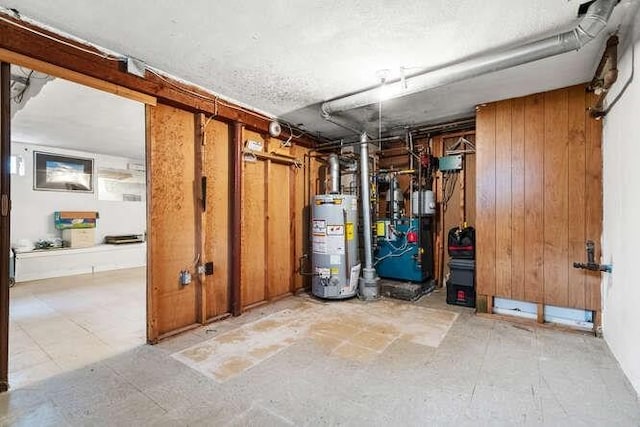 unfinished basement with a heating unit, gas water heater, and wooden walls