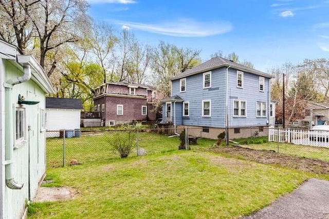 rear view of property with a lawn and fence private yard