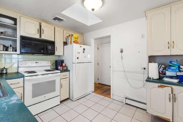 kitchen featuring decorative backsplash, white appliances, baseboard heating, light tile patterned floors, and a skylight