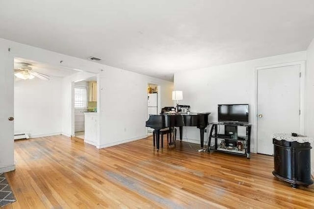 living room with ceiling fan, light wood finished floors, baseboards, a baseboard radiator, and visible vents