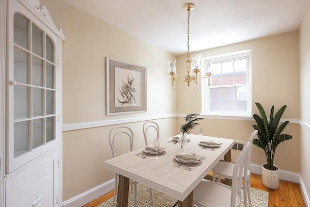 dining area with a chandelier and hardwood / wood-style floors