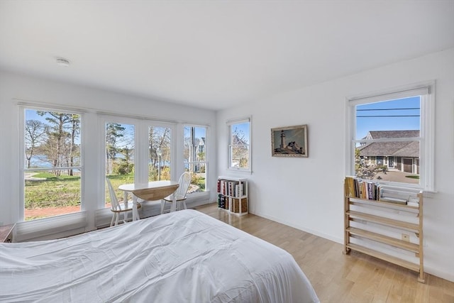 bedroom with light wood-style flooring and baseboards