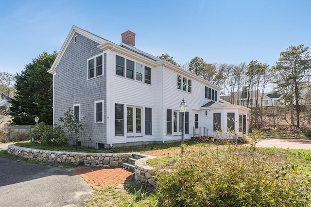 rear view of property with a chimney