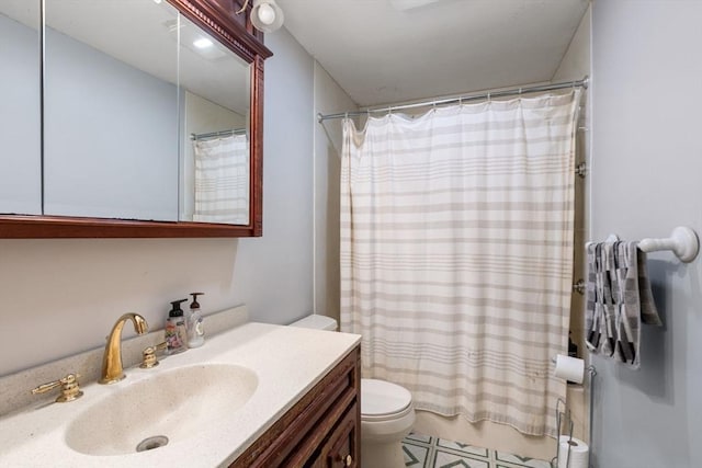 bathroom with vanity, toilet, and walk in shower