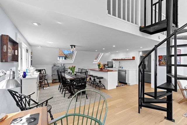 2111/2 Bradford St, Provincetown, MA 02657 - dining space featuring bar with sink, light wood finished floors, stairway, and recessed lighting