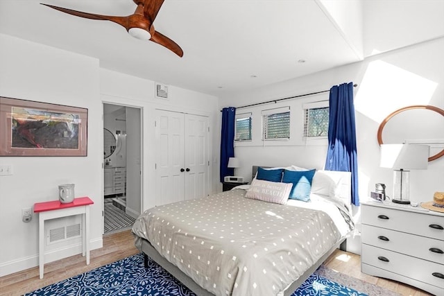 2111/2 Bradford St, Provincetown, MA 02657 - bedroom with light wood-type flooring, a closet, connected bathroom, ceiling fan, and baseboards