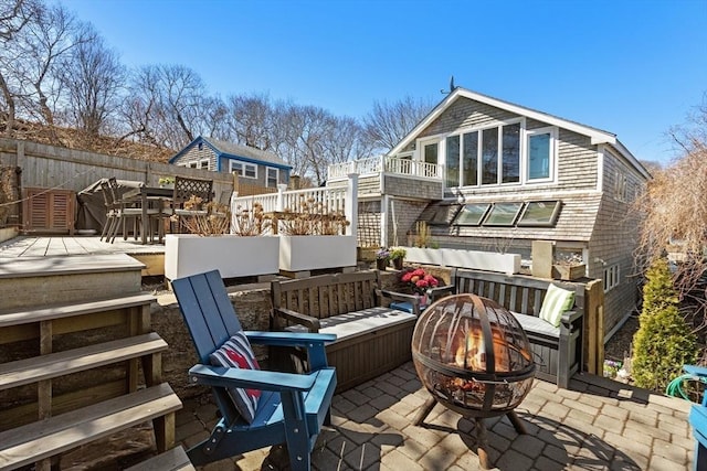 2111/2 Bradford St, Provincetown, MA 02657 - wooden terrace featuring an outdoor fire pit, a patio, and fence