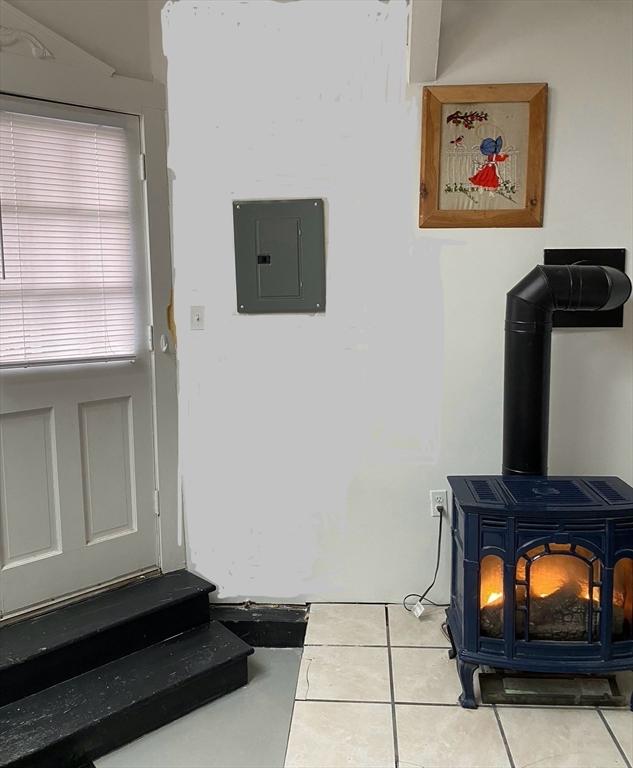 2111/2 Bradford St, Provincetown, MA 02657 - detailed view of electric panel and a wood stove