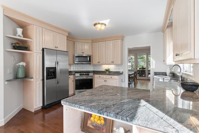 kitchen with dark wood-style flooring, open shelves, appliances with stainless steel finishes, a sink, and a peninsula