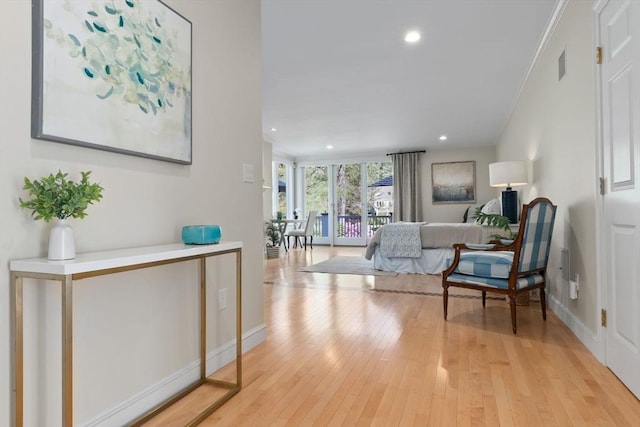 interior space with visible vents, crown molding, light wood-type flooring, baseboards, and recessed lighting