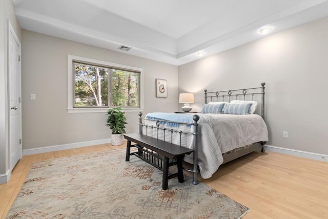 bedroom with visible vents, recessed lighting, baseboards, and wood finished floors