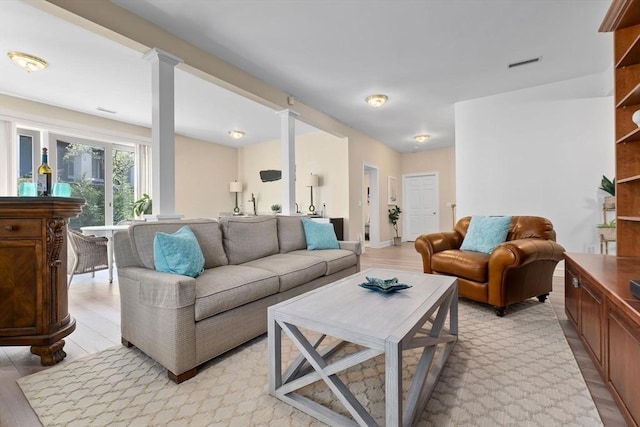 living area with ornate columns and visible vents