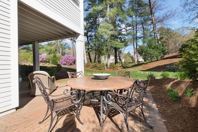 view of patio featuring outdoor dining space and a deck