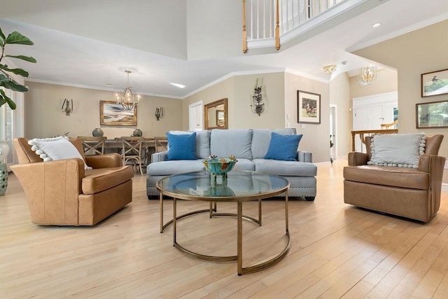 living room with an inviting chandelier and light wood-style flooring