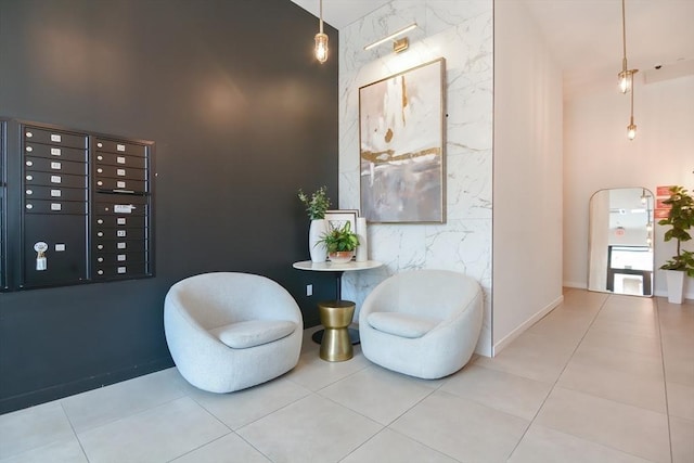 457 W Broadway Unit 209, Boston, MA 02127 - sitting room with an accent wall, mail area, and tile patterned floors