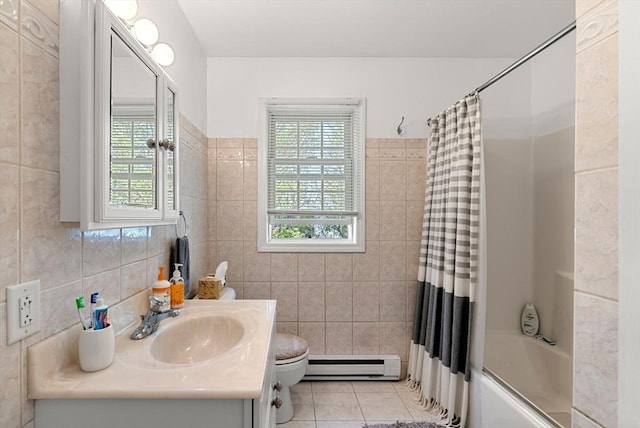 bathroom with baseboard heating, tile patterned flooring, tile walls, and a healthy amount of sunlight