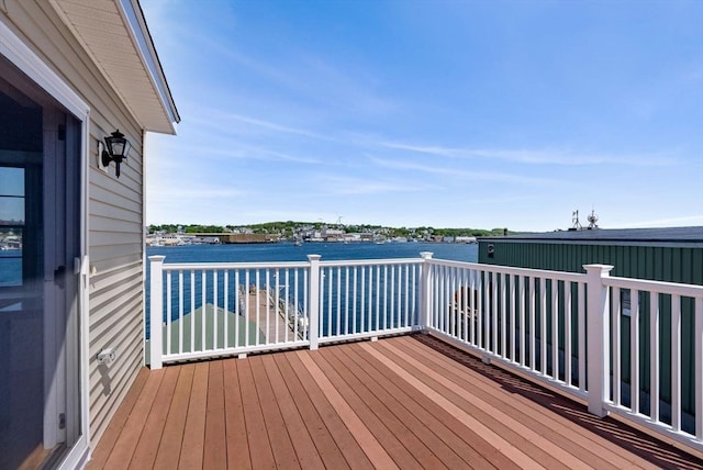 wooden terrace featuring a water view