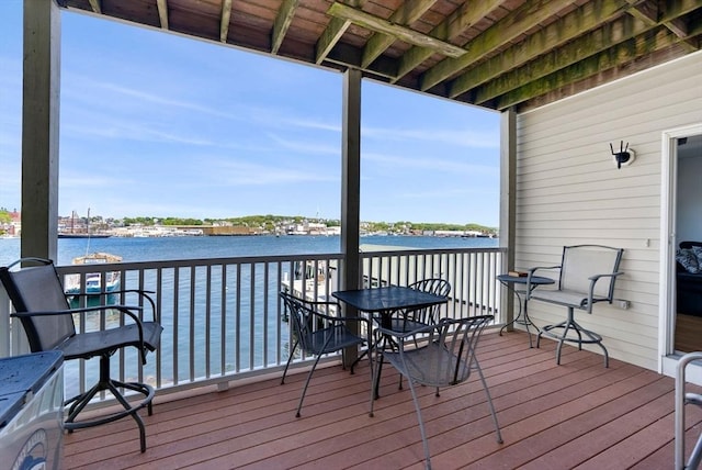 wooden deck featuring a water view