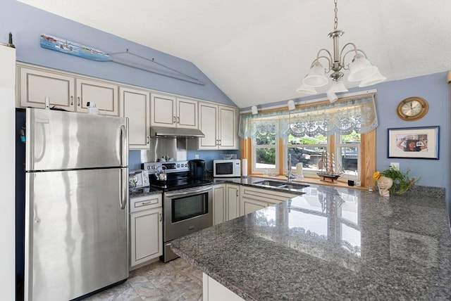 kitchen with lofted ceiling, dark stone countertops, an inviting chandelier, stainless steel appliances, and under cabinet range hood