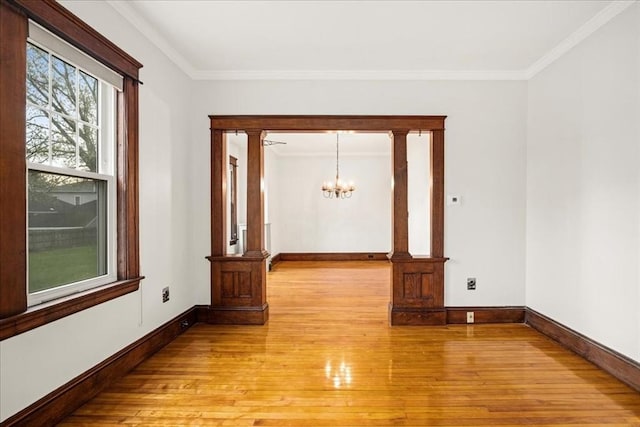 7 Vancroft Ave, Shrewsbury, MA 01545 - empty room with crown molding, light wood-style floors, baseboards, and a notable chandelier