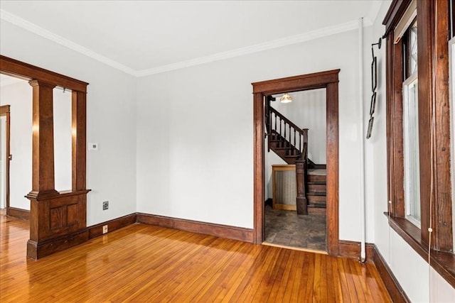 7 Vancroft Ave, Shrewsbury, MA 01545 - empty room featuring hardwood / wood-style flooring, baseboards, decorative columns, ornamental molding, and stairway