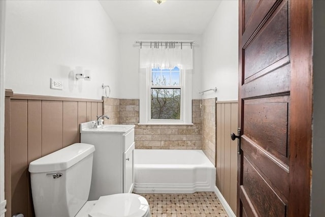 7 Vancroft Ave, Shrewsbury, MA 01545 - bathroom featuring a sink, a wainscoted wall, a bathing tub, and toilet
