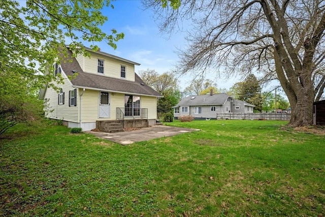 7 Vancroft Ave, Shrewsbury, MA 01545 - back of property with a yard, a patio, fence, and a shingled roof