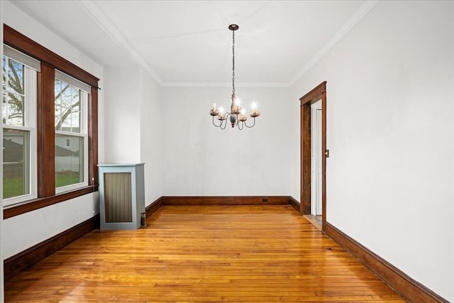 7 Vancroft Ave, Shrewsbury, MA 01545 - unfurnished dining area featuring an inviting chandelier, ornamental molding, light wood-style floors, and baseboards