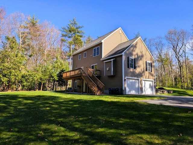 20 Warner Rd, Townsend, MA 01469 - back of property featuring an attached garage, a wooden deck, stairway, a yard, and driveway