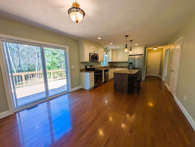 20 Warner Rd, Townsend, MA 01469 - kitchen with visible vents, baseboards, dark wood-type flooring, white cabinetry, and stainless steel appliances