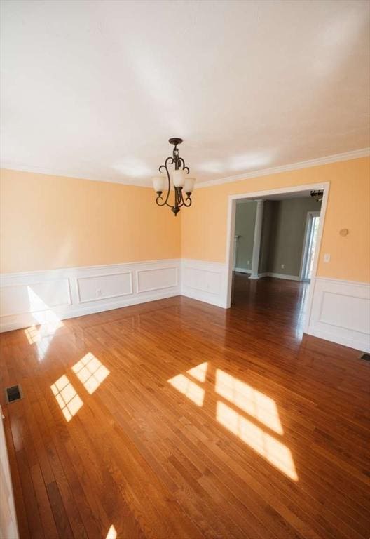 20 Warner Rd, Townsend, MA 01469 - unfurnished dining area featuring crown molding, wood finished floors, a decorative wall, a wainscoted wall, and a chandelier