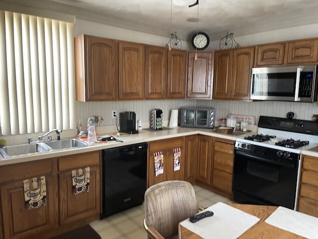 133 Main St, Everett, MA 02149 - kitchen featuring stainless steel microwave, range with gas stovetop, dishwasher, a sink, and brown cabinetry