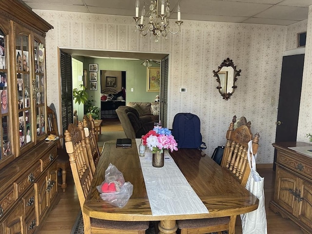 133 Main St, Everett, MA 02149 - dining room featuring a chandelier, wood finished floors, a drop ceiling, and wallpapered walls