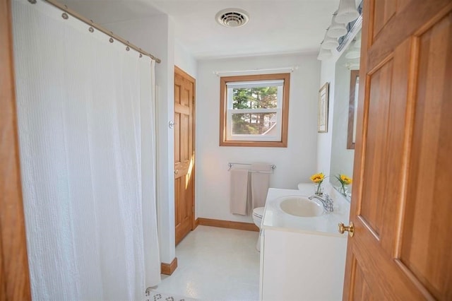 bathroom featuring toilet and vanity