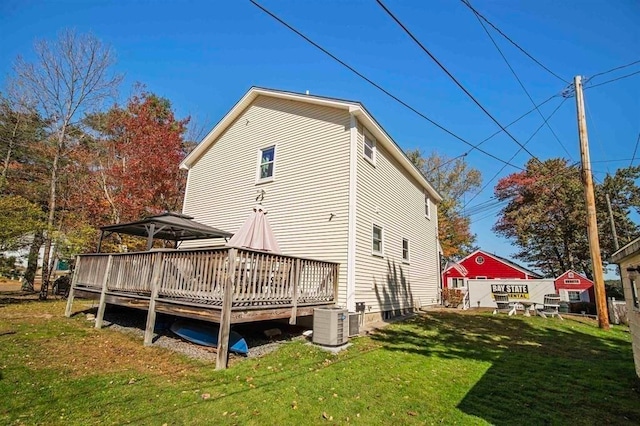 back of house with central air condition unit, a lawn, a gazebo, and a deck