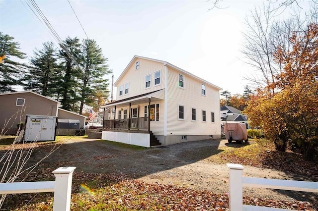 view of side of property featuring a porch