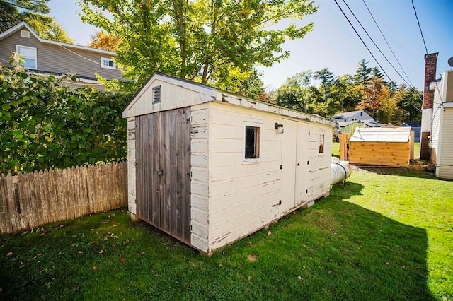 view of outbuilding featuring a lawn