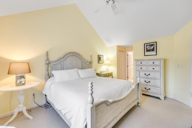 bedroom featuring light carpet, vaulted ceiling, and ceiling fan