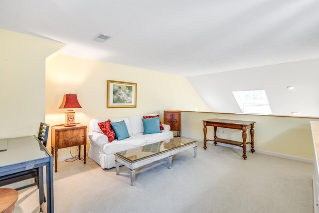 living room featuring lofted ceiling with skylight and light colored carpet