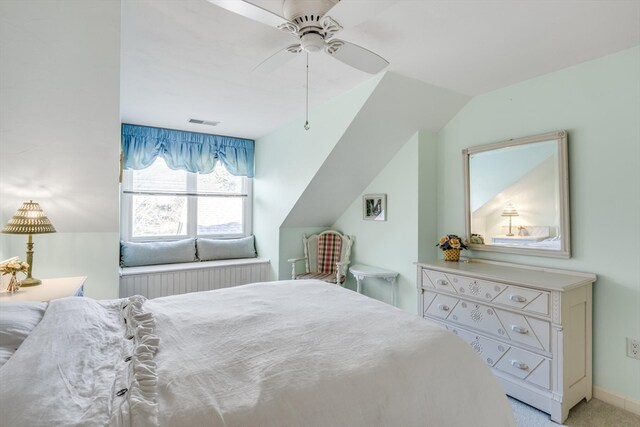 carpeted bedroom featuring vaulted ceiling and ceiling fan