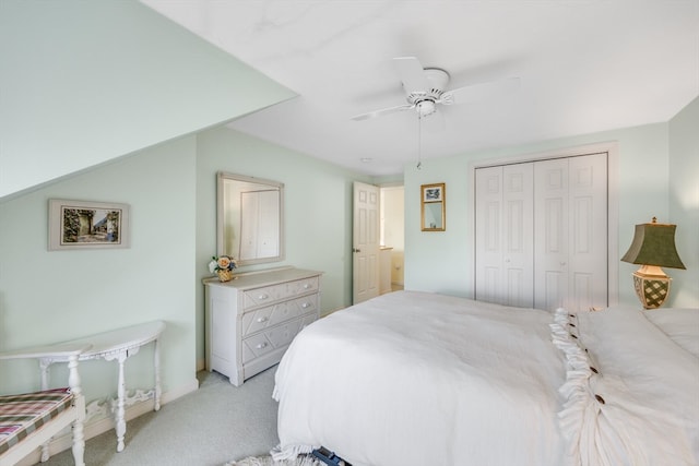 carpeted bedroom with ceiling fan and a closet