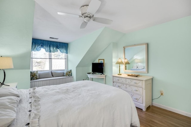 bedroom with ceiling fan, lofted ceiling, and light wood-type flooring