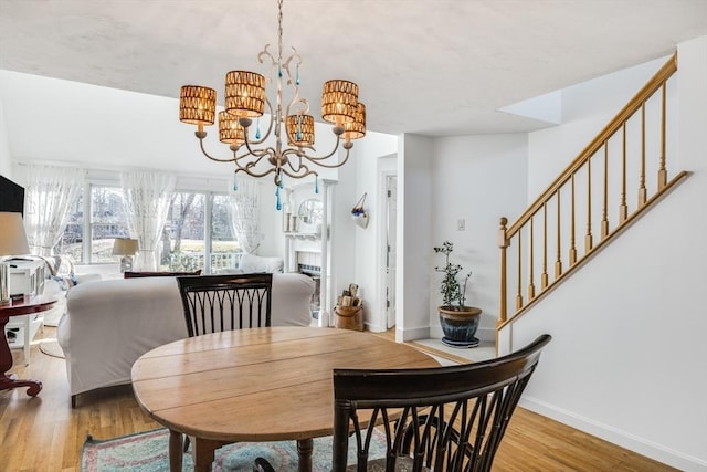 dining area with a notable chandelier and light wood-type flooring