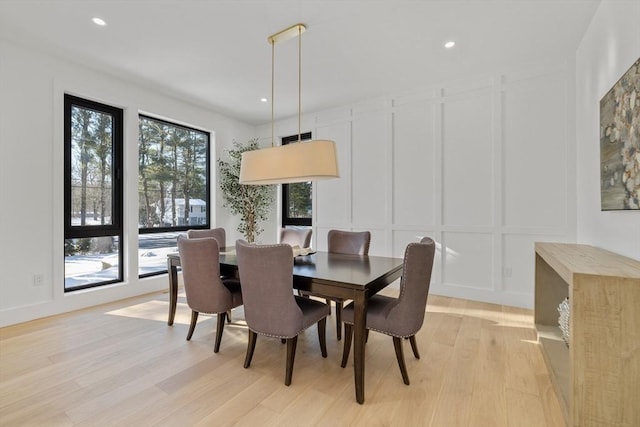 dining space featuring a healthy amount of sunlight and light hardwood / wood-style flooring